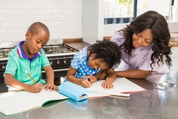 Children doing homework with their mother 