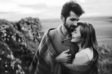 beautiful young couple on a background of rock cliff