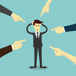 © pakphoto - Hands pointing to blame businessman