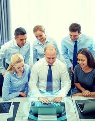 Poster - smiling business people with laptop in office