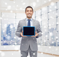 Poster - happy businessman in suit showing tablet pc screen