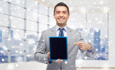 Poster - happy businessman in suit showing tablet pc screen