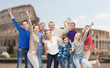 © Syda Productions - group of happy people having fun over coliseum