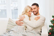 © Syda Productions - happy couple hugging on sofa at home