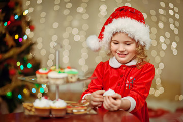 Merry Christmas - Little pretty girl in hat holding plate with c