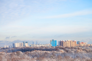 Sticker - white clouds in blue sky over snow forest and town