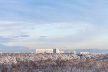 Sticker - blue clouds in blue sky over snow forest and town