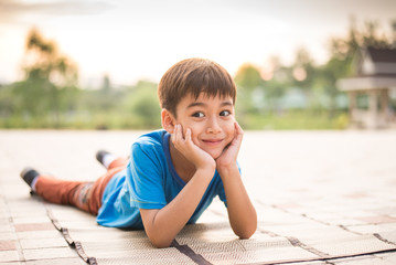 Wall Mural - Little boy sitting in the park alone