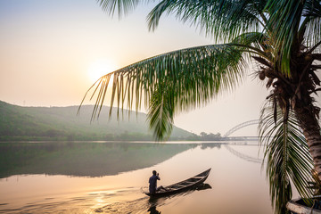 paddling in traditional wooden canoe