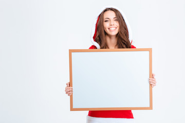 Poster - Smiling woman in santa claus cloth holding blank board