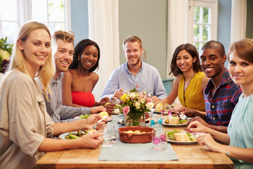 Wall Mural - Friends At Home Sitting Around Table For Dinner Party