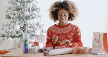 Happy Young African Woman Wrapping Presents