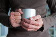 © Sunlove - Two male hands holding a cup of coffe or tea