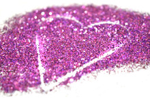 Blurry Abstract Background With Heart Of Purple Glitter Sparkle On White Surface
