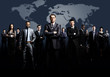 © ASDF - business team formed of young businessmen standing over a dark background