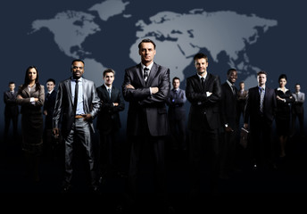 business team formed of young businessmen standing over a dark background