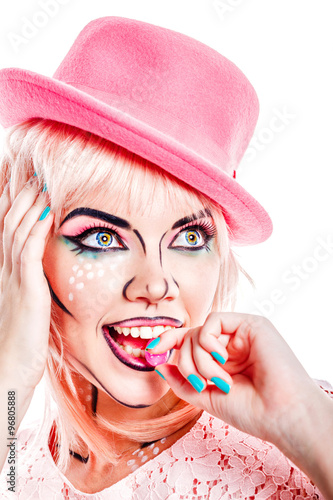 Fototapeta na wymiar Girl with makeup in style pop art is eating candy.