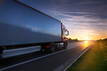 Wall Mural - Red truck at sunset