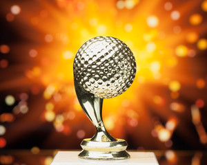 Wall Mural - golf ball trophy against shiny sparks background