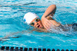 Close up action shot of teen swimmer.