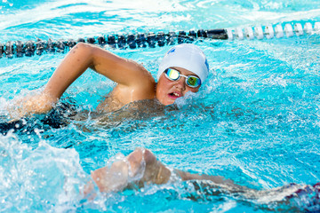 Teen boy competing at swimming gala.