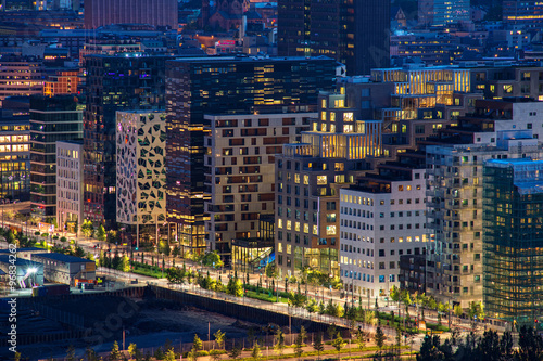 Fotografering Oslo, Norway - July 15, 2015: Night view of illuminated street in the Oslo business center
