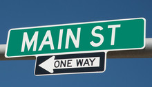 Main Street On Green Overhead Highway Sign With One Way Arrow 