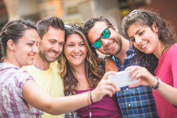 Group of tourists or friends taking a selfie in Pisa, Italy,  They are two men and three women. Lifestyle, friendship and travel concepts.