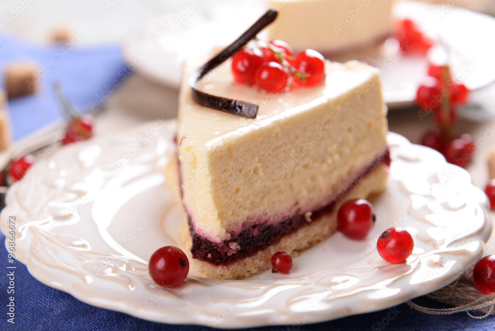 Tasty cheesecake with berries on table close up