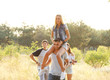 © Africa Studio - Joyful friends relaxing, a girl on guy's shoulders in the forest outdoors