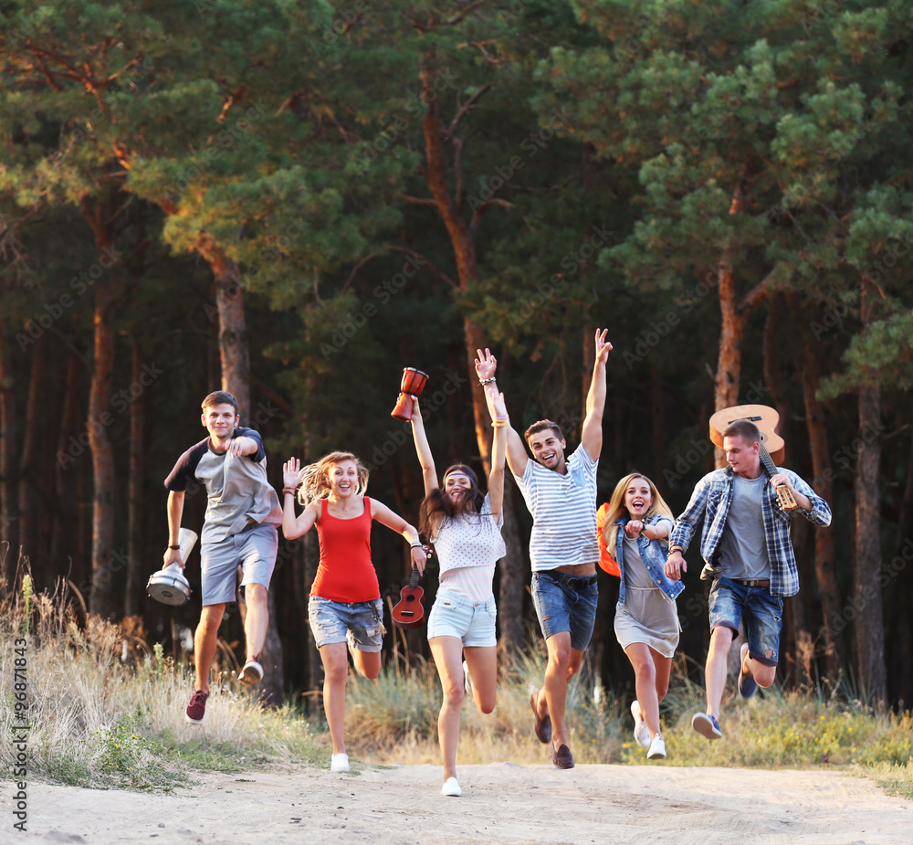 Happy friends have fun close to the forest