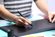 © Africa Studio - Female hand drawing on the graphic tablet in the office, close-up