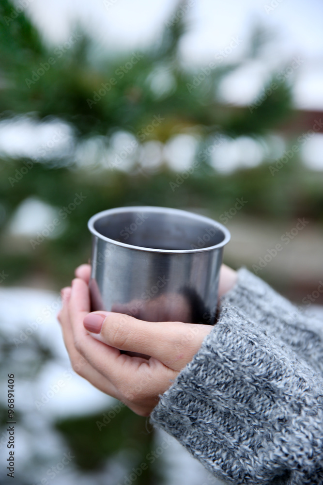 Hand holding coffee cup, outdoors
