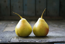 Two Yellow Pear Twins On Wooden Floor, Still Life