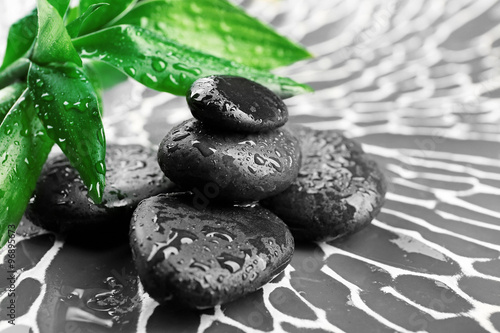 Naklejka na szybę Spa stones and bamboo branch on dark background