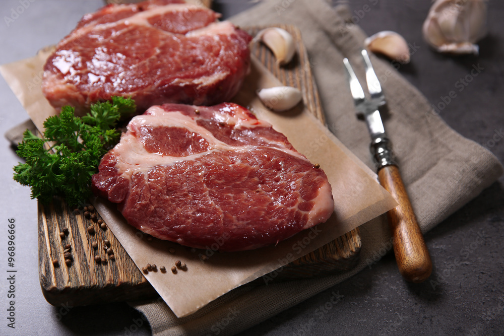 Marbled beef steak and spices on wooden background