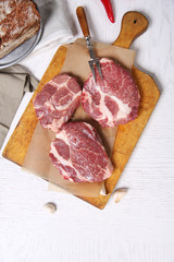 Marbled beef steak and spices on wooden background