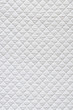 Closeup of white quilted fabric