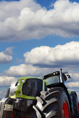 Poster - Big tractor on background of the cloudy sky