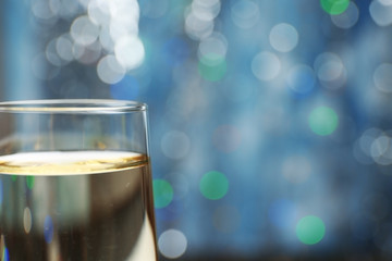 A glass of champagne on blue blurred background