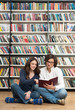 © ImageFlow - smiling young girl and young man sitting on the floor in the lib