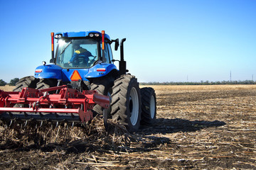 Poster - Farmer on a tractor plowed field