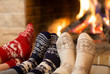 © Andrey Kuzmin - Feet in wool socks near fireplace in winter time