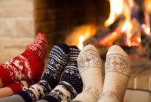 Feet In Wool Socks Near Fireplace In Winter Time