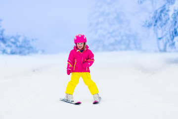 Wall Mural - Little child skiing in the mountains in winter