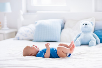 Wall Mural - baby boy in white sunny bedroom