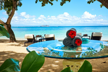 Wall Mural - Table under tropical tree on white sand beach