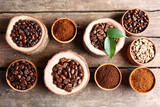 Fototapeta Mapy - Different coffee beans on wooden table, close up