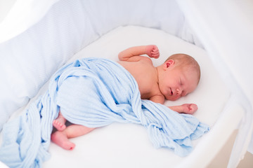 Wall Mural - cute newborn baby in white bed
