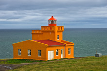 Orange Lighthouse At The Most Northern Point Of Iceland Coast